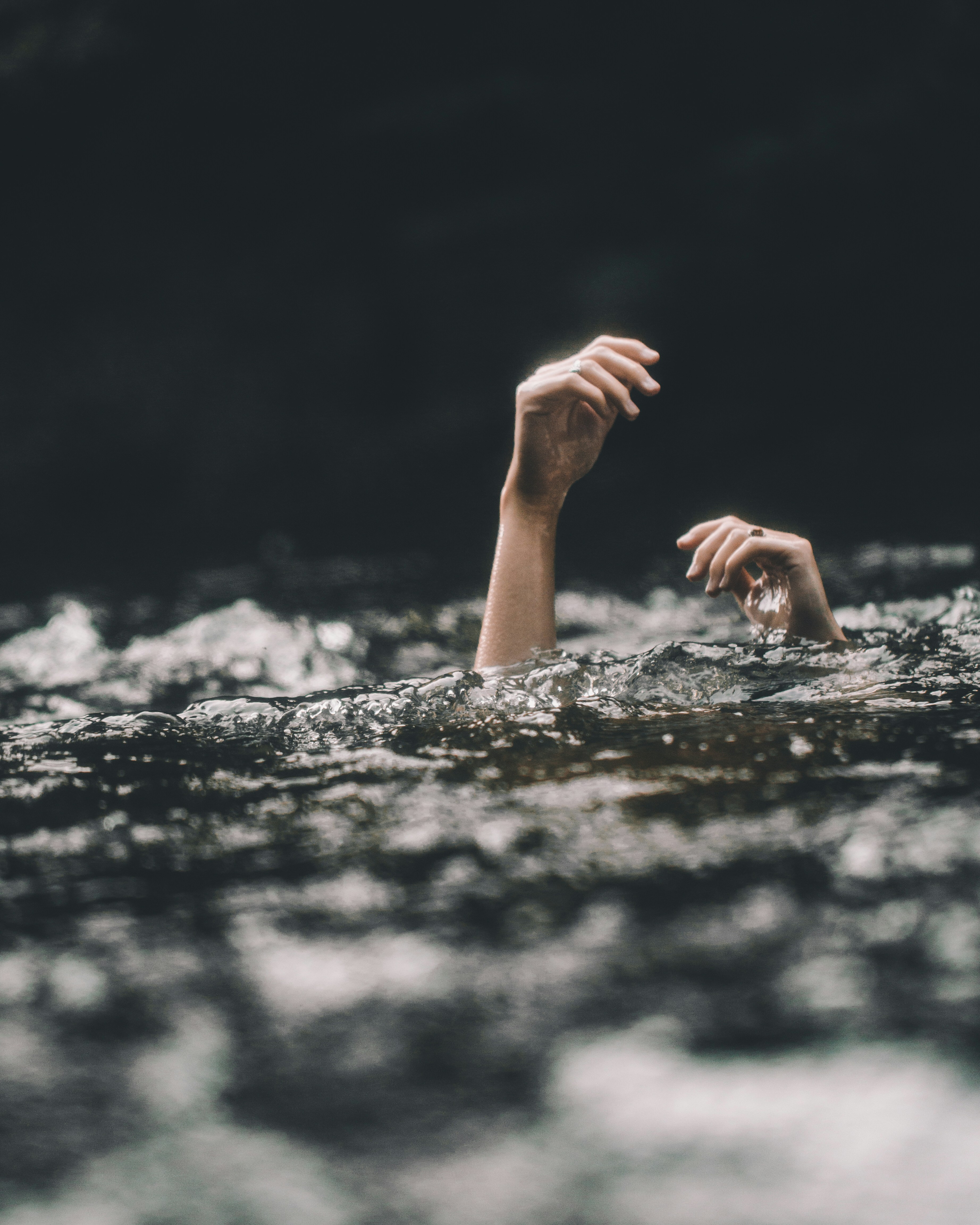 Hands popping up from the water. You're not sure if it's someone drowning in the despair of being replaced by AI or if it's the AI, rising out of the water. Photo by Blake Cheek on Unsplash