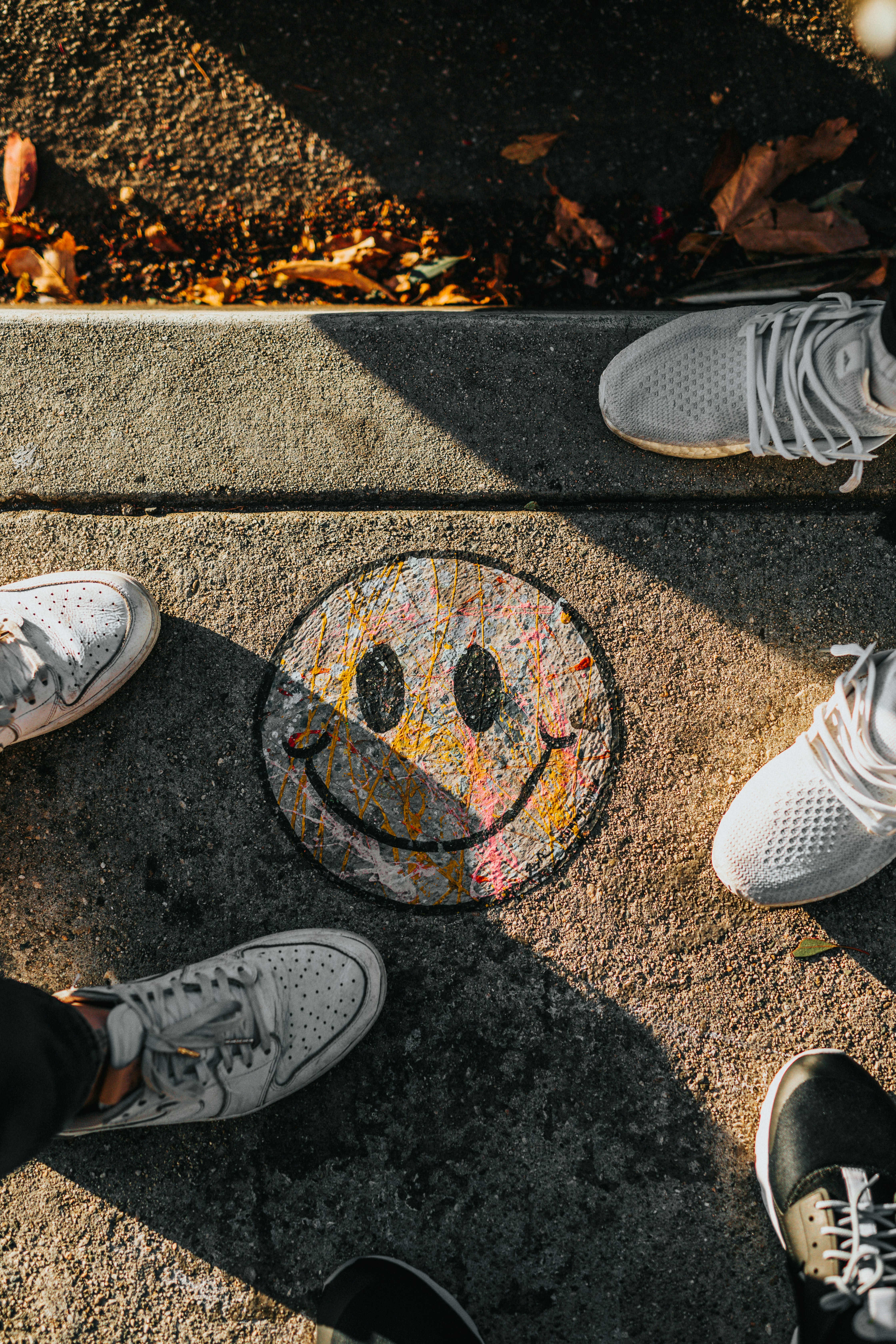 A smiley face drawn on the ground. It's unclear whether the smile is genuine or hiding disappointment, much like feedback can sometimes feel. Photo by Nathan Dumlao on Unsplash